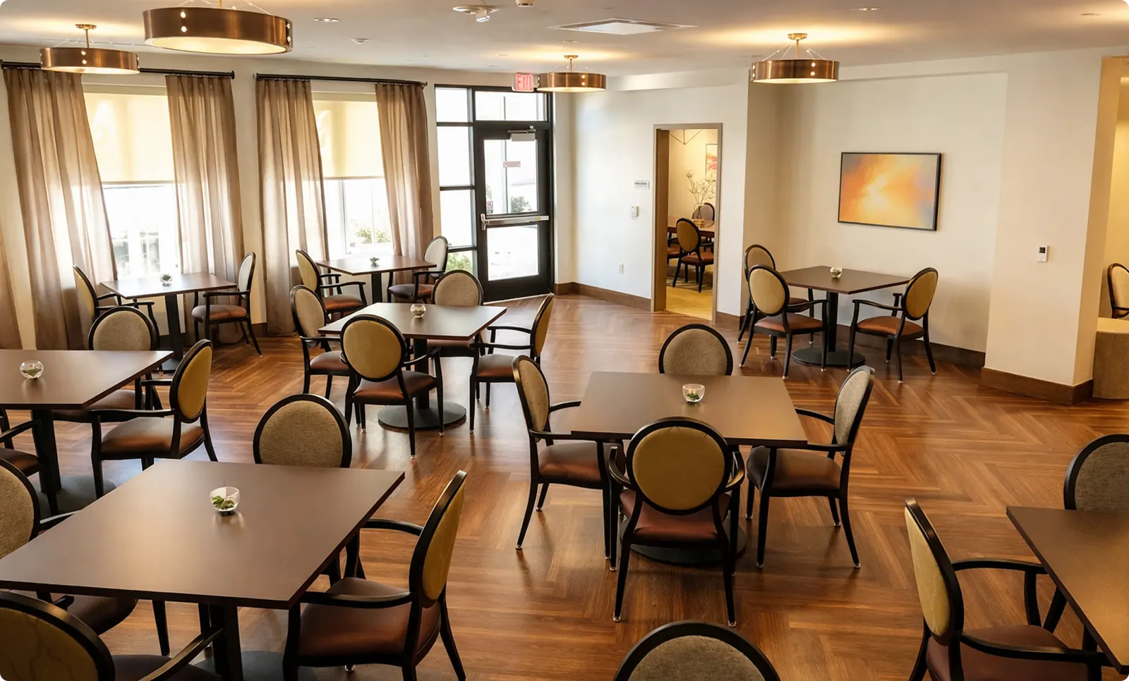 A café-style dining room with round tables and large windows