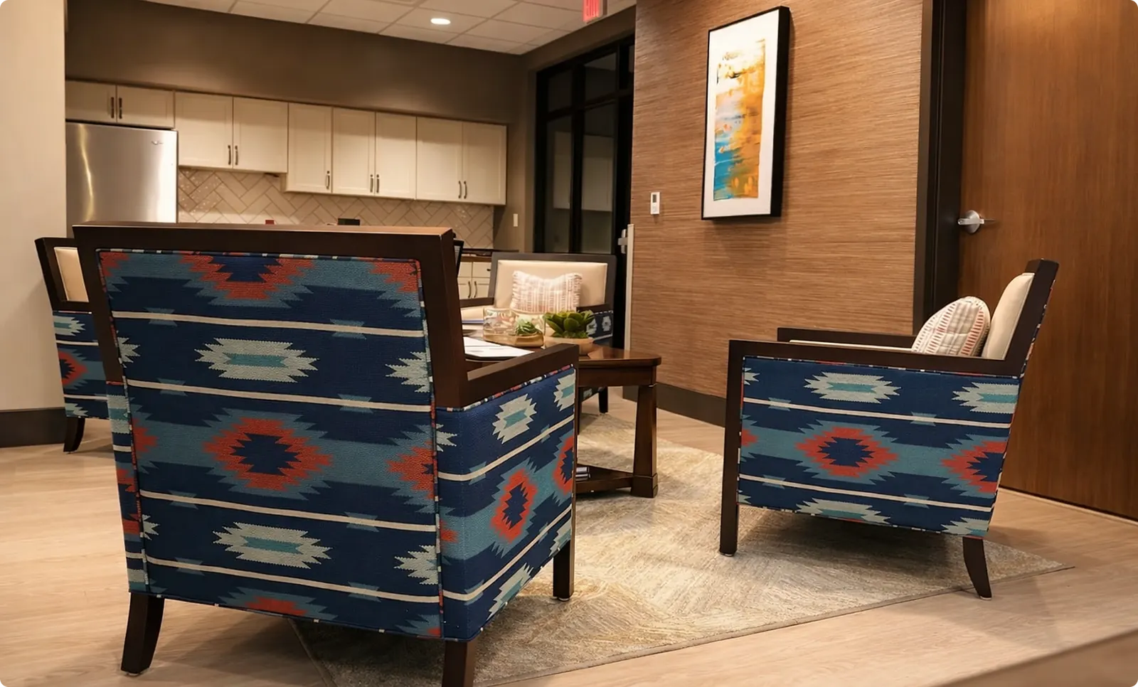 A conversation lounge with patterned armchairs and an area rug