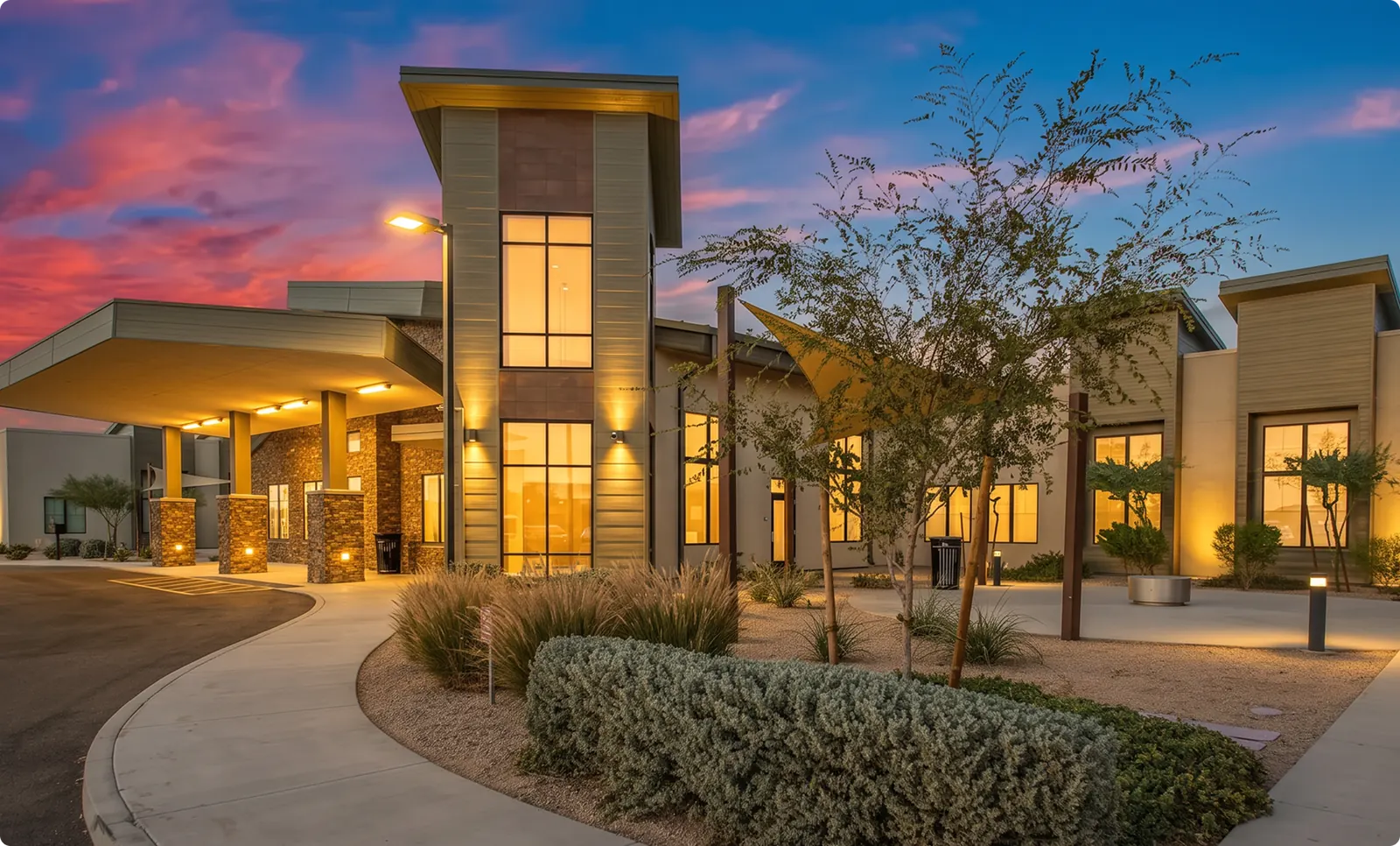 The Buena Vista facility at dusk, with an illuminated entrance and curved driveway