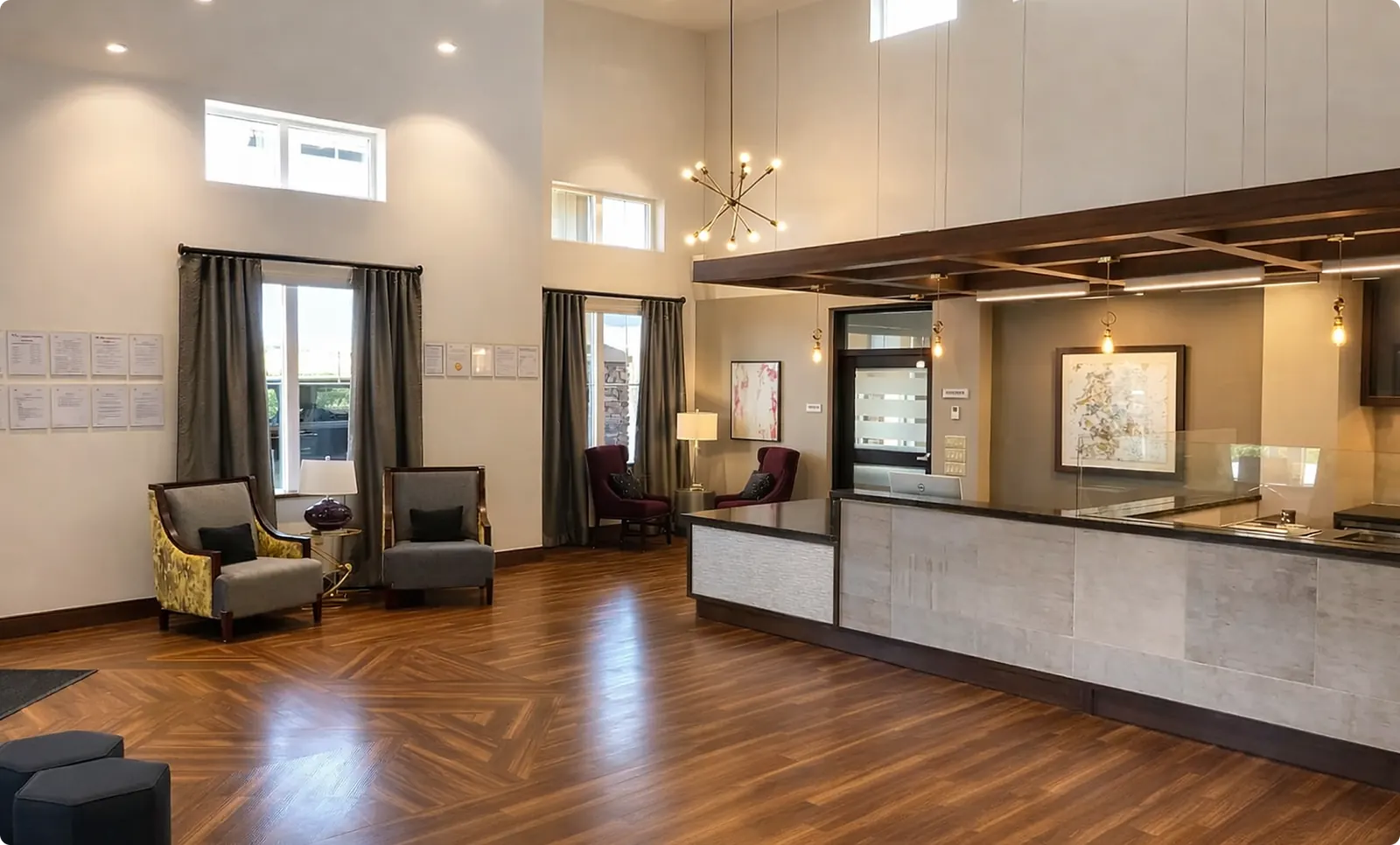 The concierge lobby at Buena Vista in Chandler, with a reception counter under a double-height ceiling