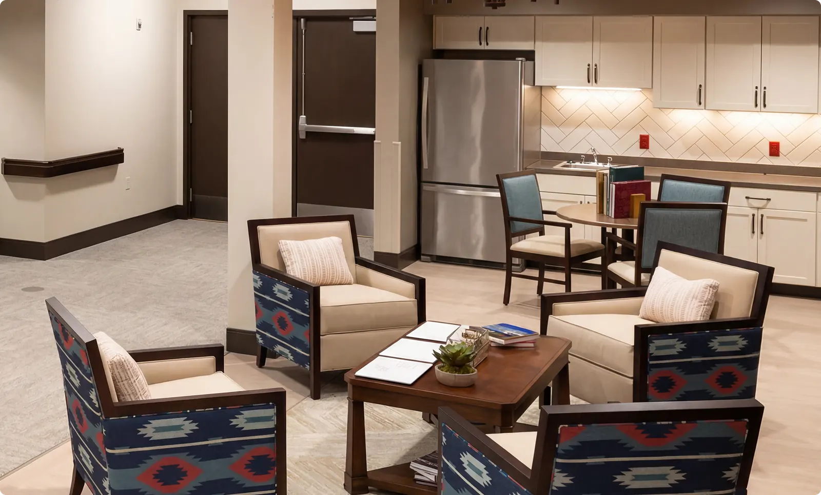 A commons area at Buena Vista with armchairs clustered around a low table