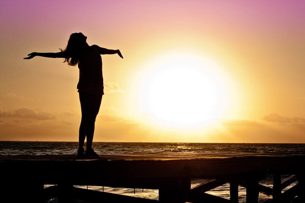 woman standing on dock near water