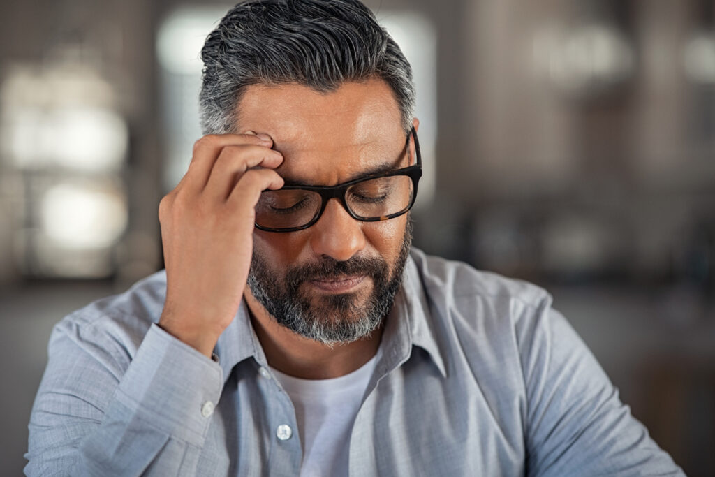 Stressed and frustrated man with headache