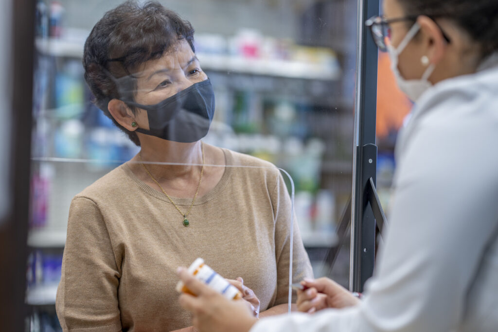 Picking up prescription medicine at the pharmacy