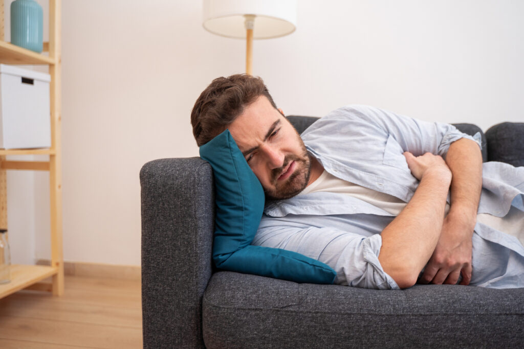 Man portrait suffering stomach ache at home