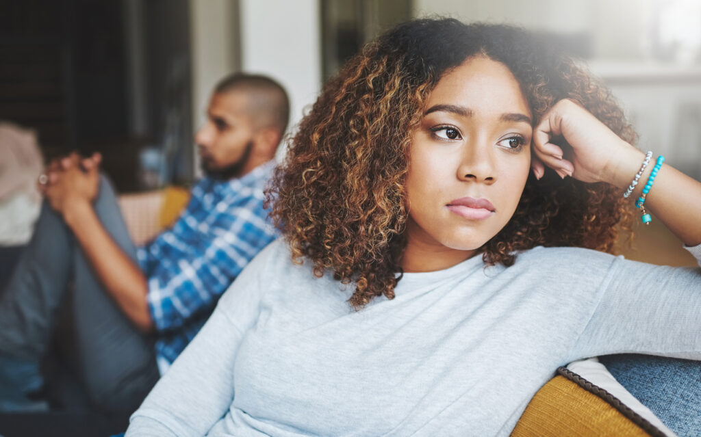 Shot of a young woman looking tired and uninterested.