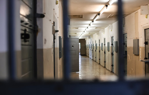 A hallway of jail cells.